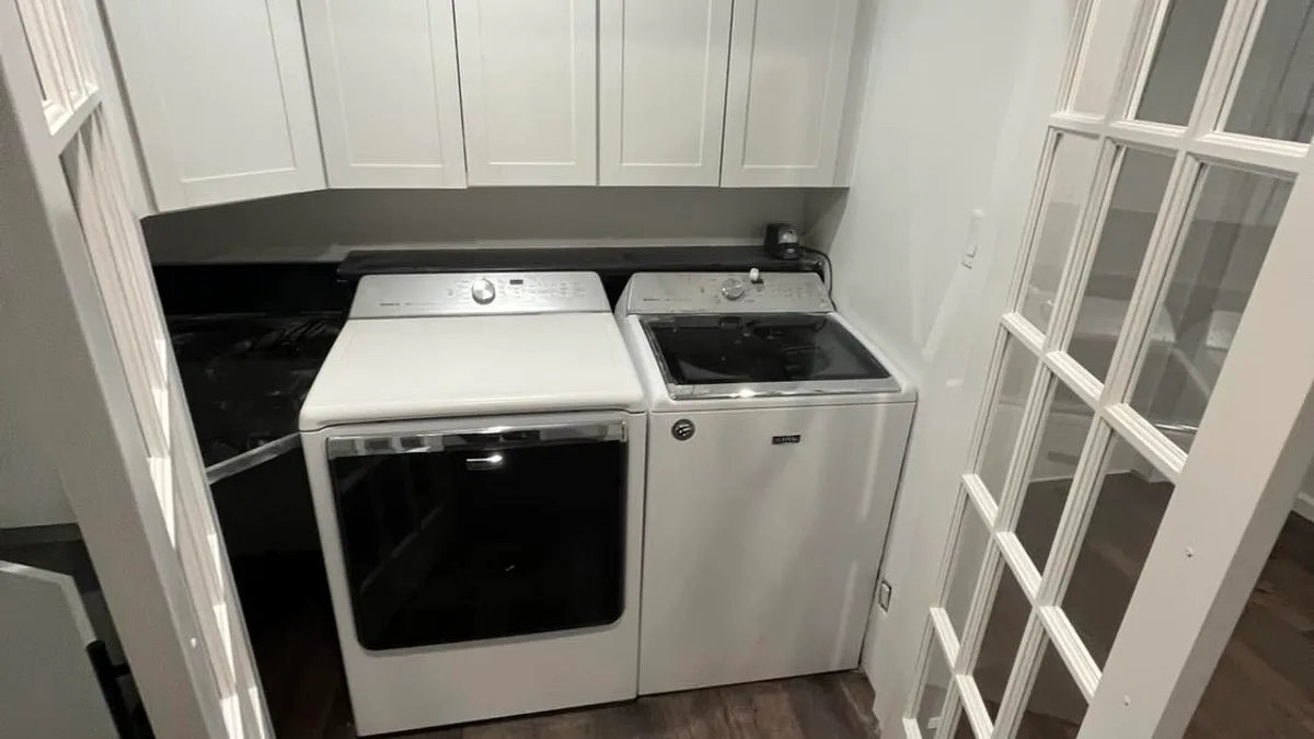 Painted laundry room walls, cabinets, and trim